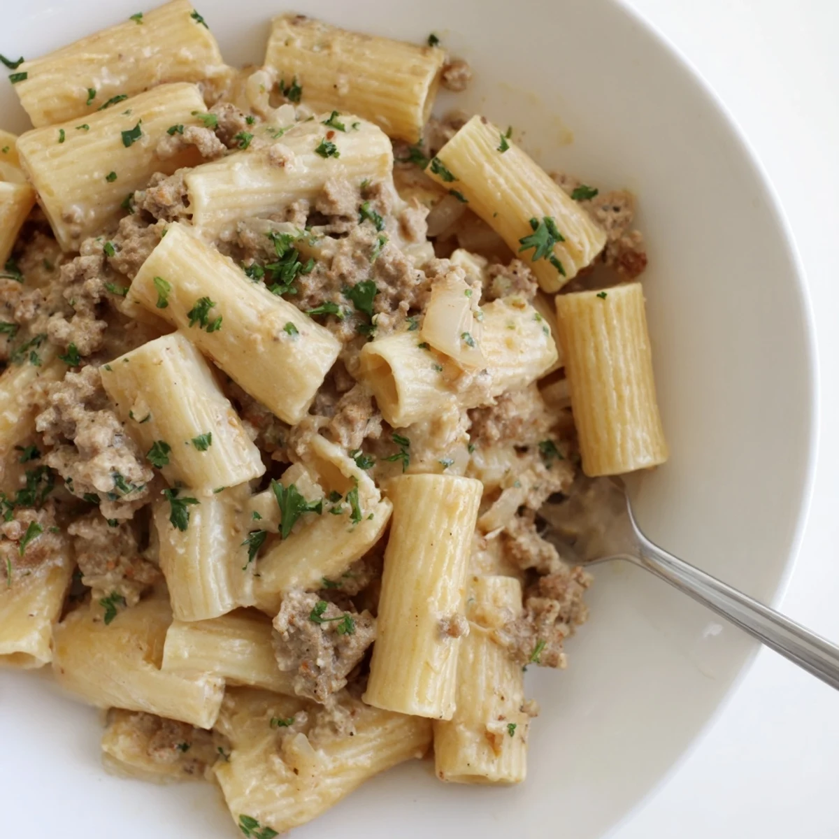 Creamy Cheesy Ground Turkey Pasta topped with fresh herbs for a hearty meal.  