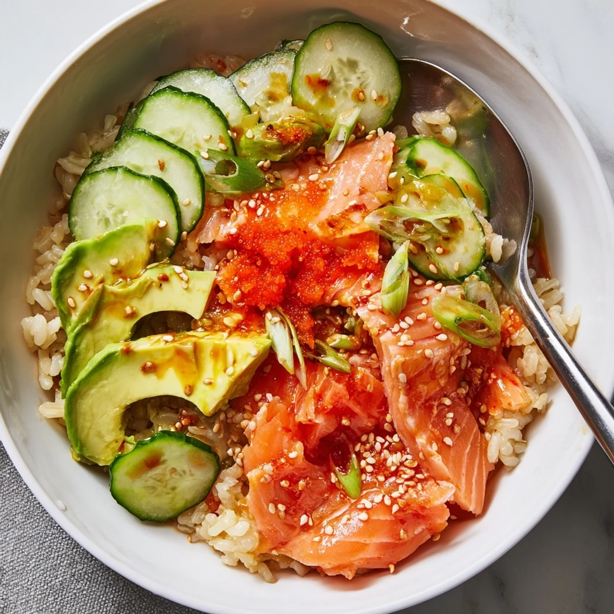 Quick and easy Leftover Salmon & Rice Bowl drizzled with soy sauce and sesame oil.