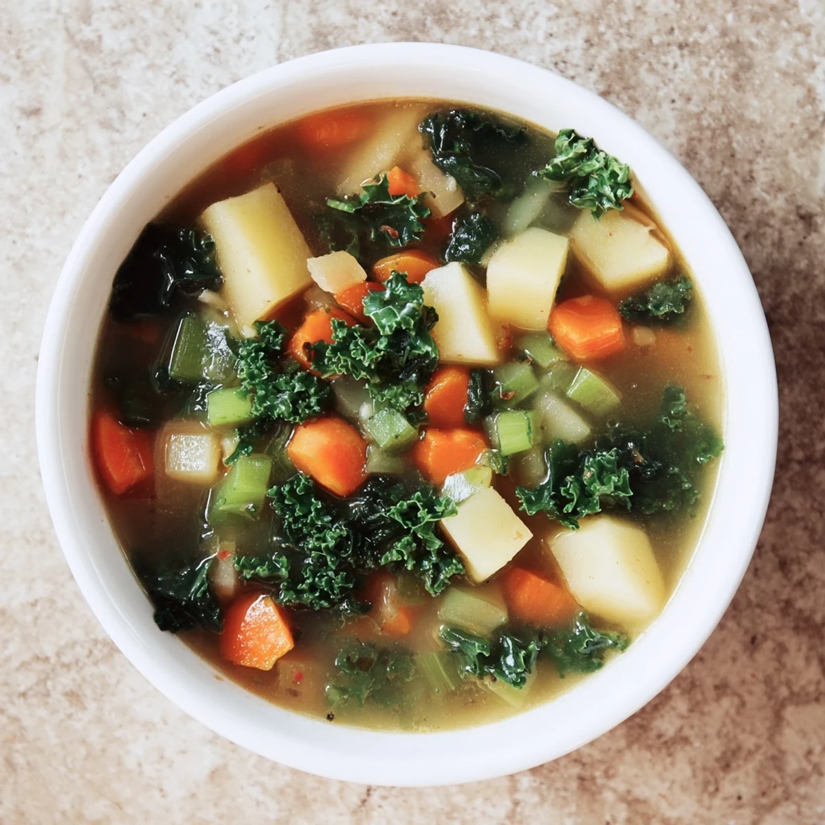 A vibrant close-up of Vegetarian Potato-Kale Soup, showcasing tender potatoes and healthy kale.