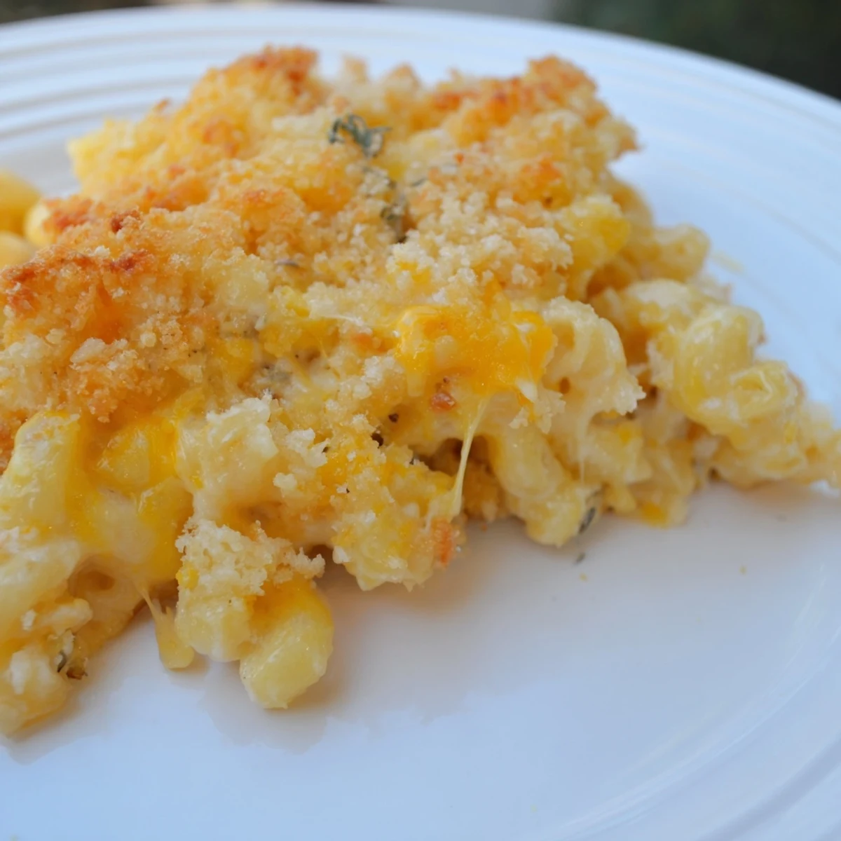 Golden, bubbly baked Mac & Cheese with Evaporated Milk, ready for a comforting, cheesy bite.