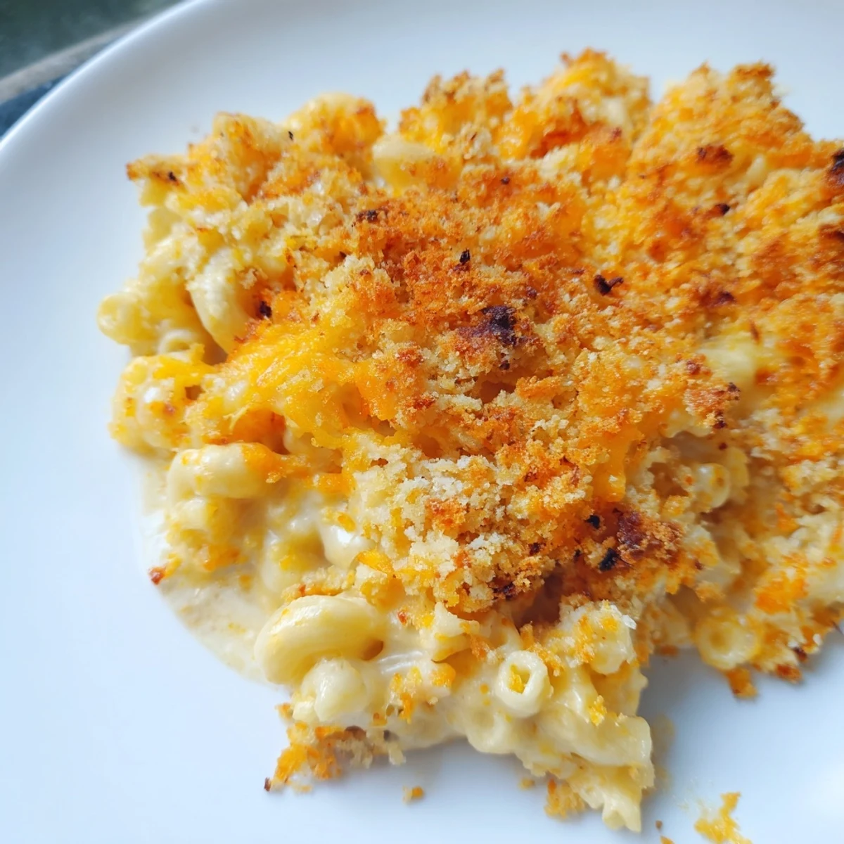 Golden crust on bubbly Baked Macaroni and Cheese, a creamy, cheesy, and utterly delicious casserole dish.