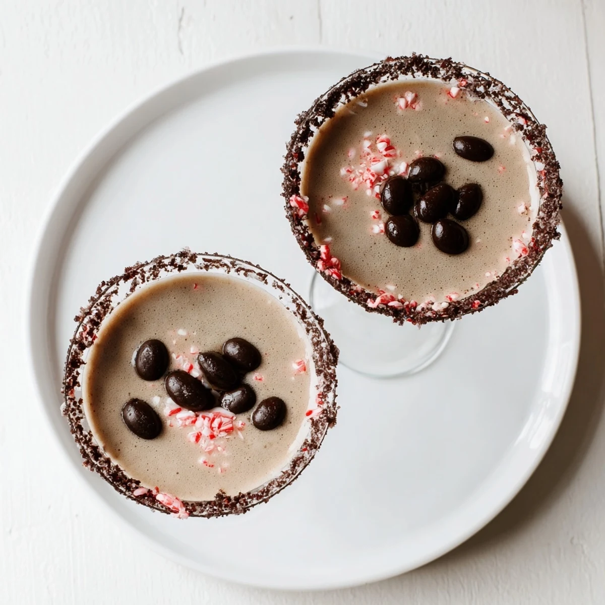 Festive Peppermint Espresso Martinis served in chocolate-peppermint-rimmed glasses, perfect for any celebration.