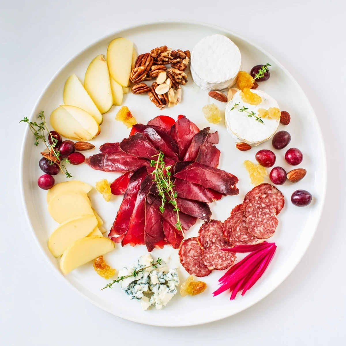Luscious Majestic Venison Charcuterie Platter showcasing cured meats, creamy cheeses, fresh grapes, and crunchy nuts, ready to enjoy.