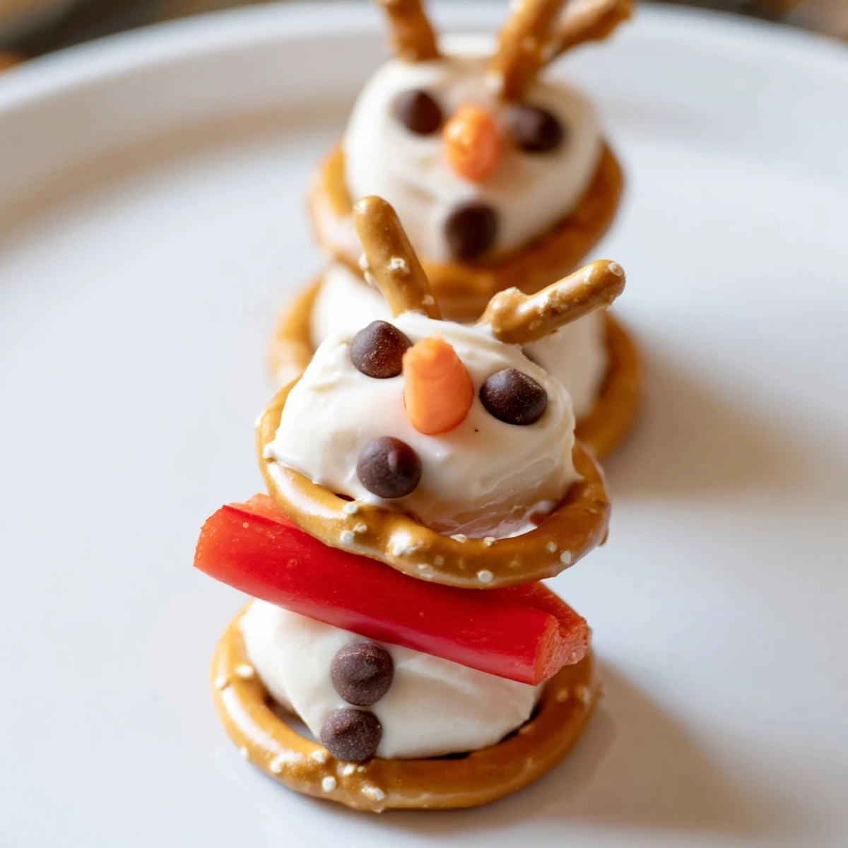 Bright image of a snowman pretzel, delightful for kids, served with fresh dips perfect for parties.