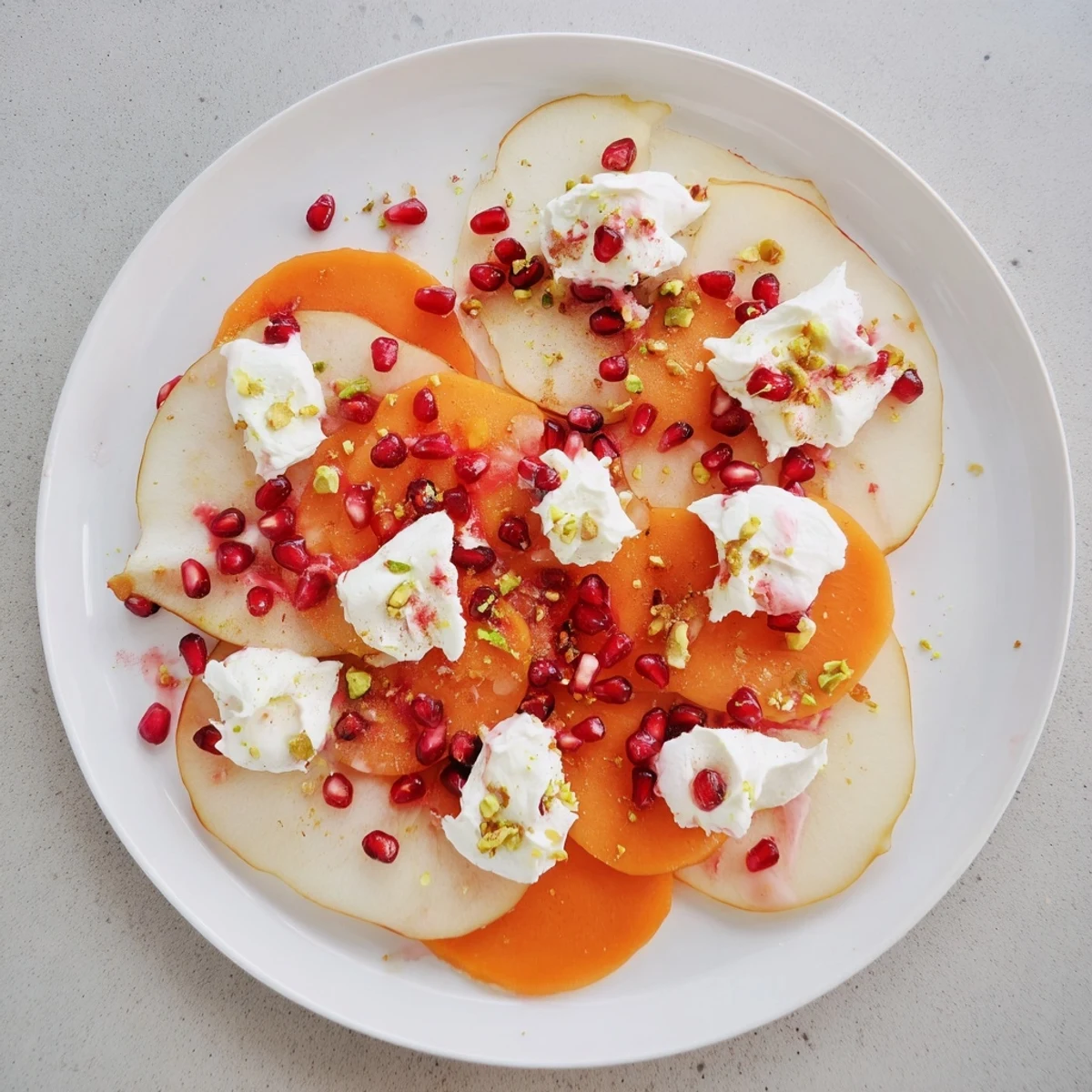 Vibrant persimmon and pear snowscape dessert, a beautiful arrangement of fruit with creamy mascarpone.