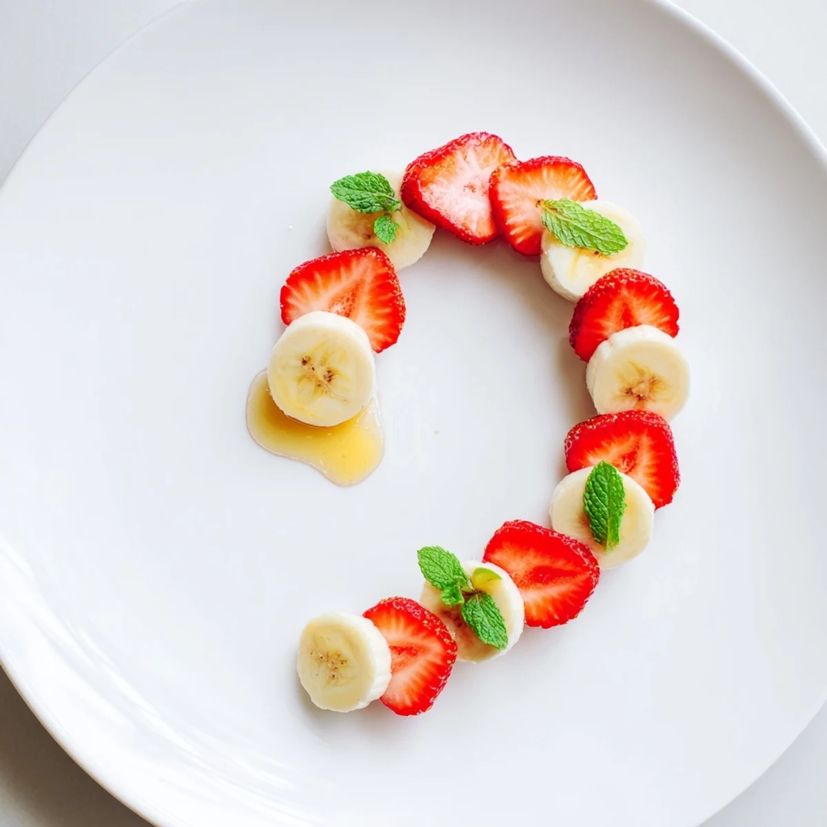 Strawberry Banana Candy Cane arranged on a plate; a colorful, refreshing, and festive snack.