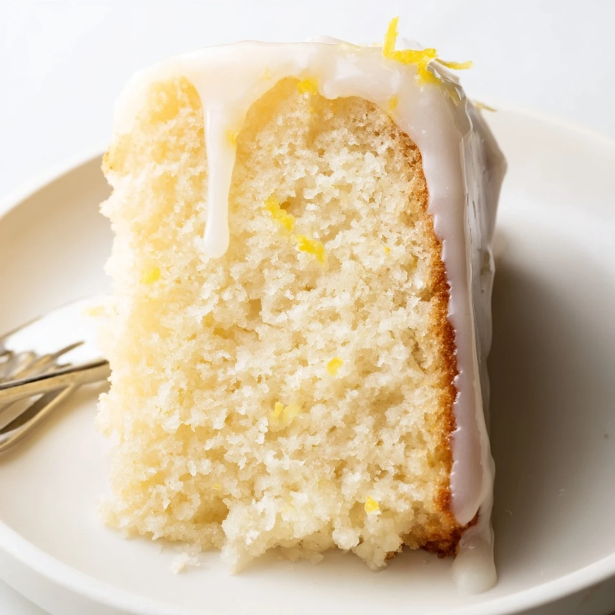 Fluffy Lemon Yogurt Cake, drizzled with sweet lemon glaze, ready for a delicious dessert.