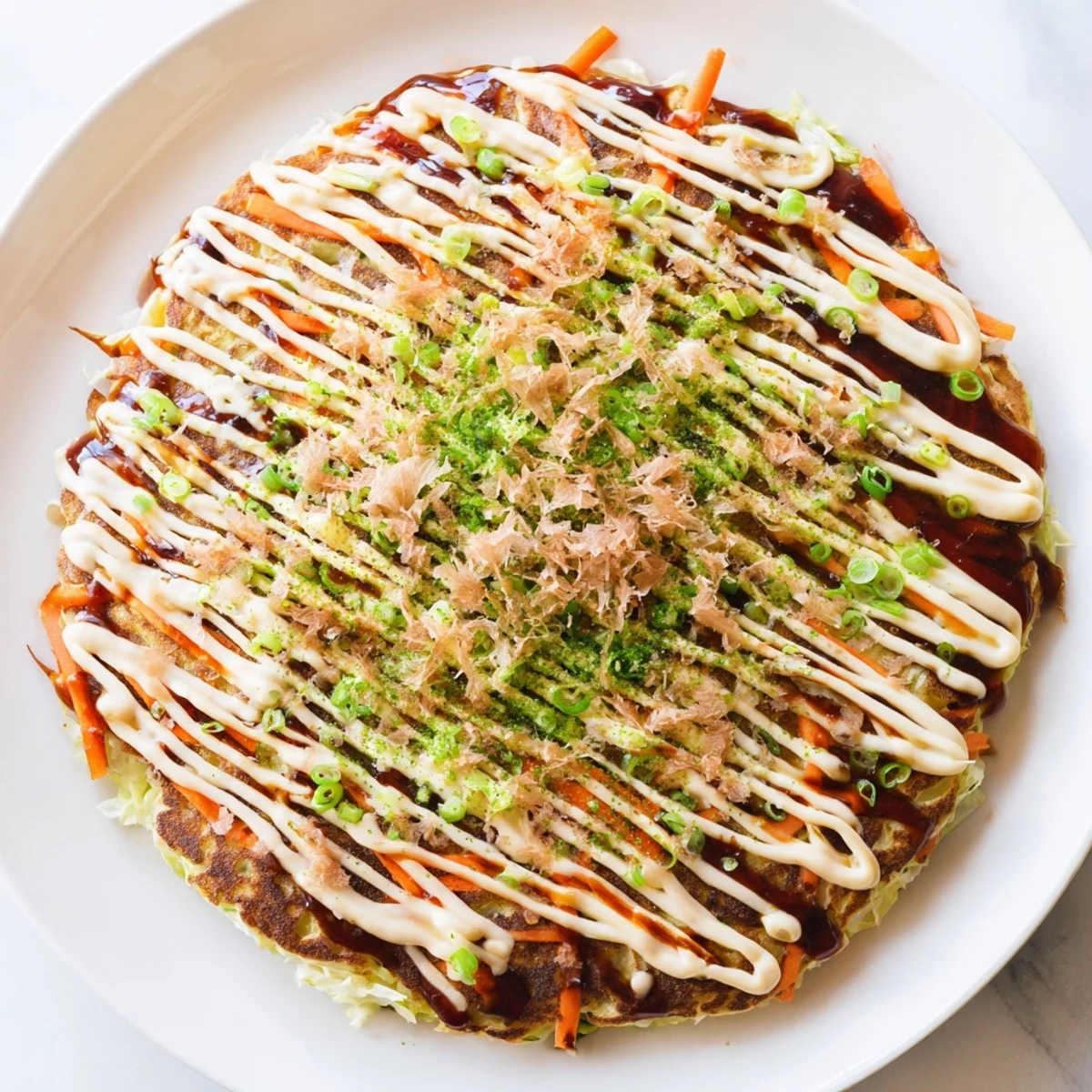 A close-up of steaming, delicious Japanese okonomiyaki pancakes, ready to be devoured with sauce and mayo.