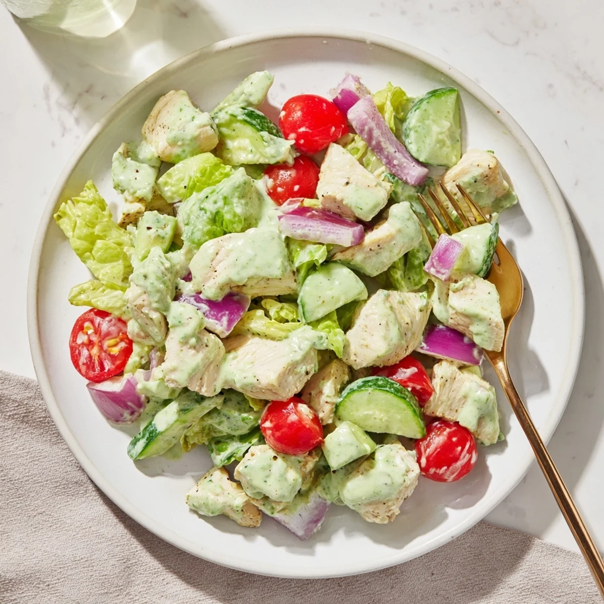 Healthy avocado ranch chicken salad with diced celery, red onion, and fresh herbs, ideal for a gluten-free lunch.