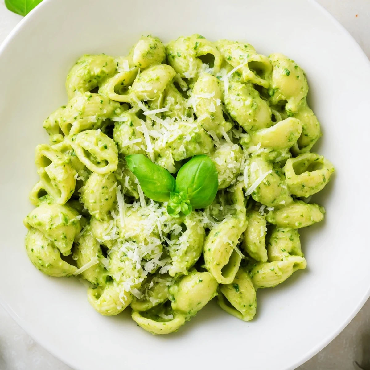 This Creamy Avocado Pesto Mac pairs perfectly with a crisp side salad on a rustic wooden table.