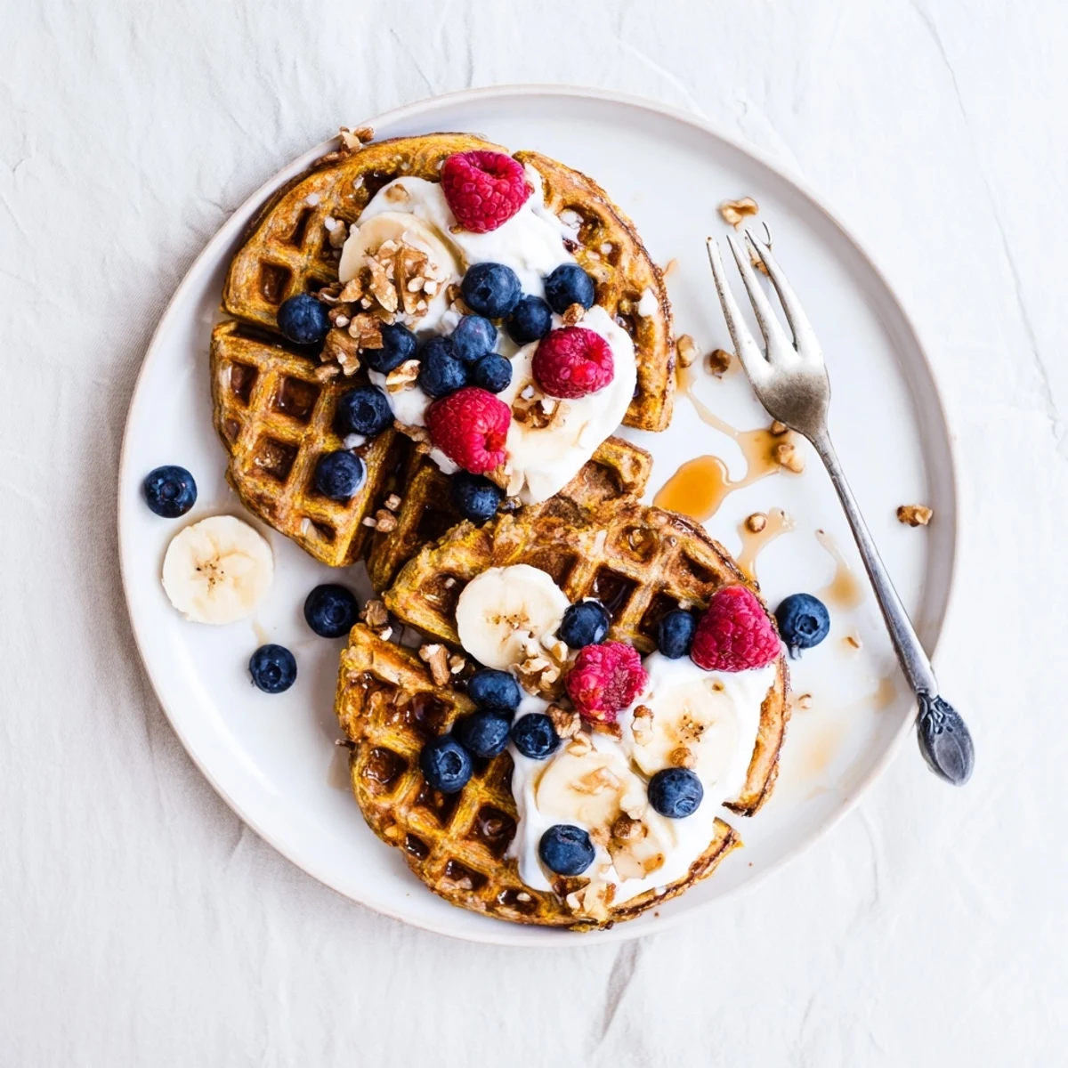 Golden, fluffy Anti-Inflammatory Adaptogenic Turmeric Waffles fresh from the iron, perfect with fresh berries and a drizzle of maple syrup.