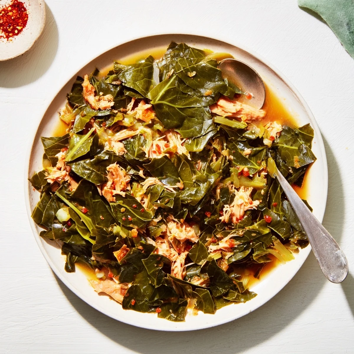 Steaming Southern-style collard greens with smoked turkey, a hearty and flavorful side dish.