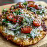 Bubbling cheese and golden edges on a deliciously easy Crispy Garlic Parmesan Naan Pizza, ready to slice and serve for a quick dinner.