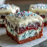 Moist Patriotic Poke Cake layered with colorful gelatin and rich white chocolate.