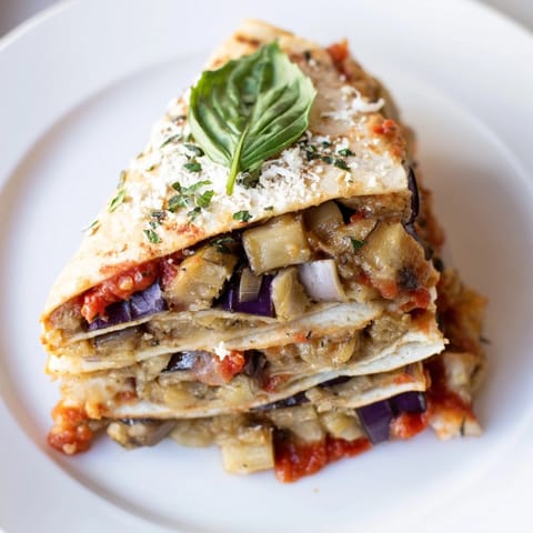 Crispy Cheesy Eggplant Parmesan Quesadillas, a flavorful fusion, served warm with fresh basil.