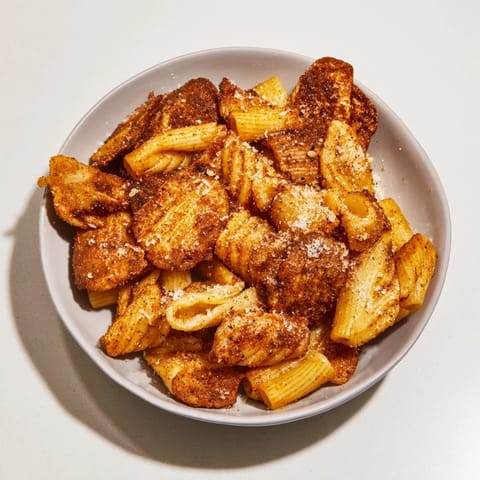 Baked pasta chips drizzled with olive oil and aromatic spices for flavor.  