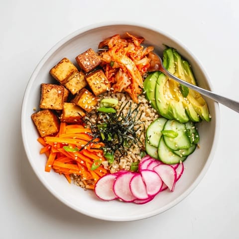 Vibrant fermented vegetable bowl featuring creamy avocado and crunchy radishes.  