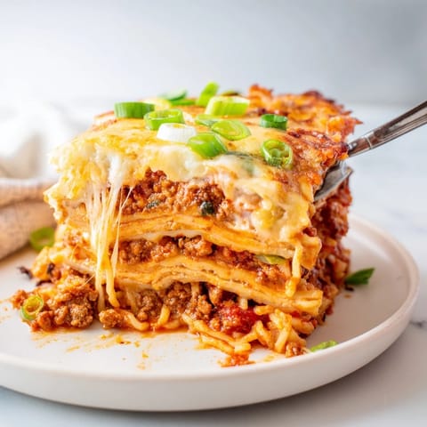 A mouthwatering Spicy Ramen Lasagna bursting with flavors and garnished with green onions.  