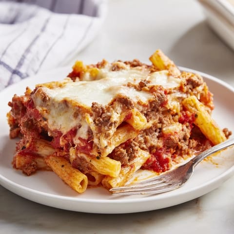 A warm Cheesy Beef & Penne Bake, bubbling with rich tomato sauce and cheesy goodness.  