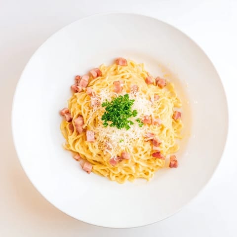 A steaming bowl of Carbonara Ramen awaits, the cheesy sauce clinging deliciously to the noodles.