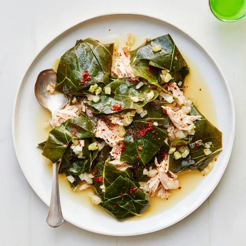 Close-up of tender, slow-cooked Southern style collard greens with savory smoked turkey visible.