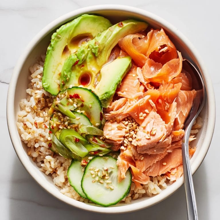 Savory Leftover Salmon & Rice Bowl garnished with pickled ginger and sesame seeds.  
