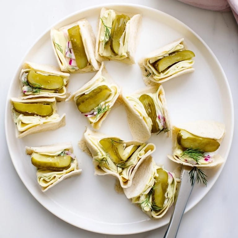 Deliciously tangy Pickle-in-a-Blanket snacks, perfect for picnics or parties.  
