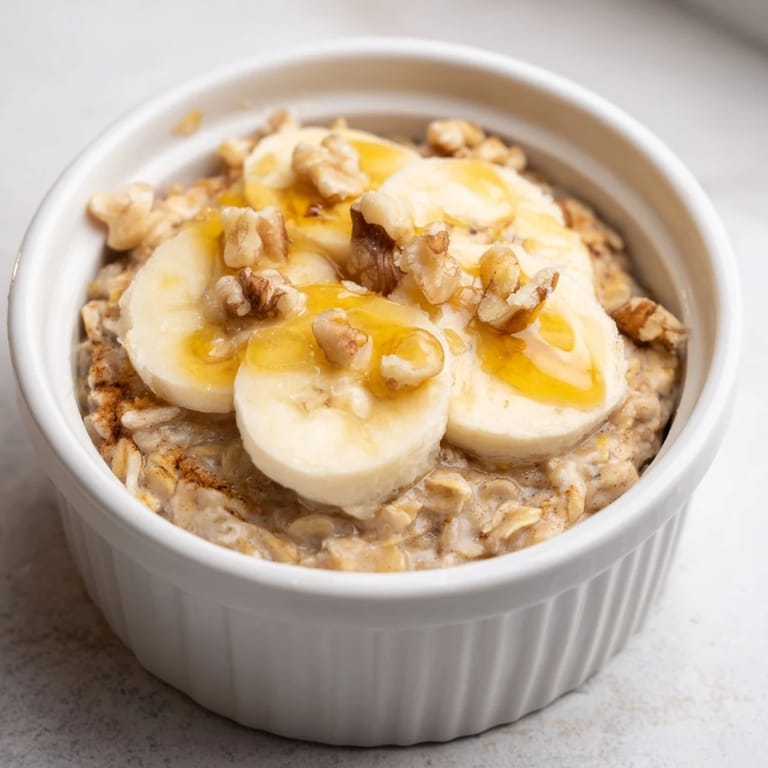 Individual ramekins of Baked Oats with Banana, fragrant with cinnamon and baked until bubbly, ready to serve.