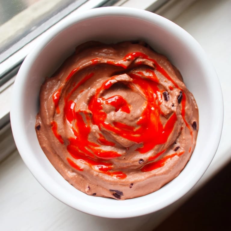 Homemade Spicy Black Bean Dip, a beautiful blend of flavors, is perfect alongside fresh vegetables for dipping.