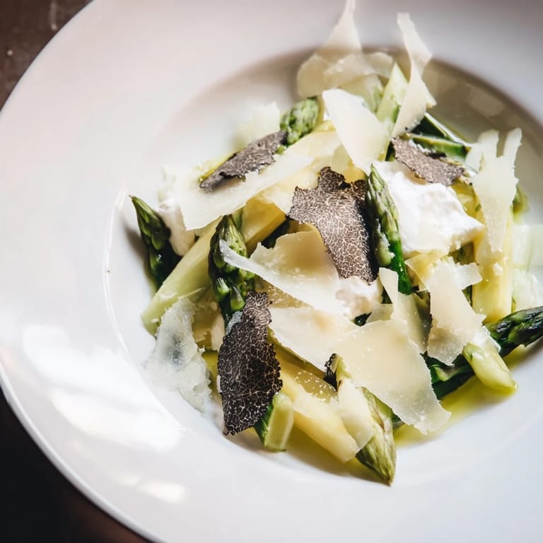 Glimpse the The Silver Birch: delicate white asparagus salad with truffle stripes and rich burrata, ready to savor.