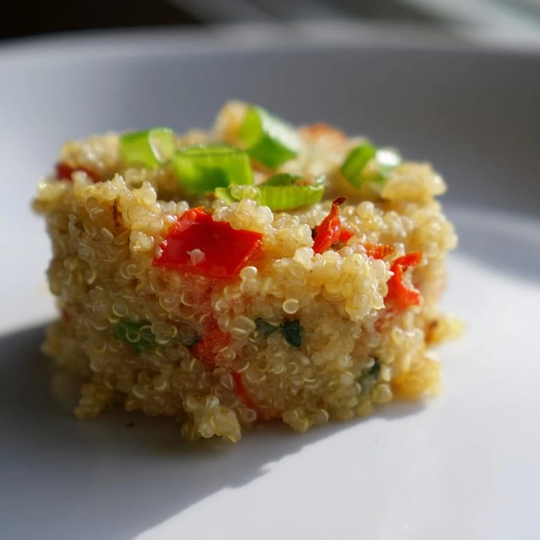 Freshly baked cheddar quinoa bites with vibrant vegetables, perfect as a healthy appetizer.