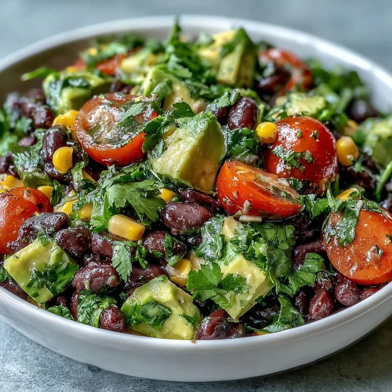 Freshly tossed Black Bean and Veggie Bowl featuring hearty beans, crisp red onion, and cilantro, ready for a light lunch.